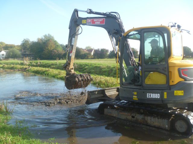 Digger working in river at Seaton