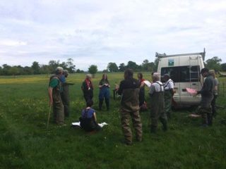 group of particpants in Invertebrates Day event dressed in waders