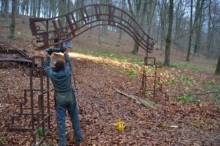 man using angle grinder to cut metal sculpture in Kings Wood