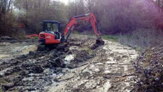 Excavator digging out a pond