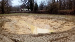 excavated depression with rainwater