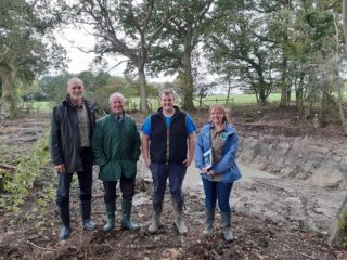 4 people fo rth eGCN Project in a newly created pond.