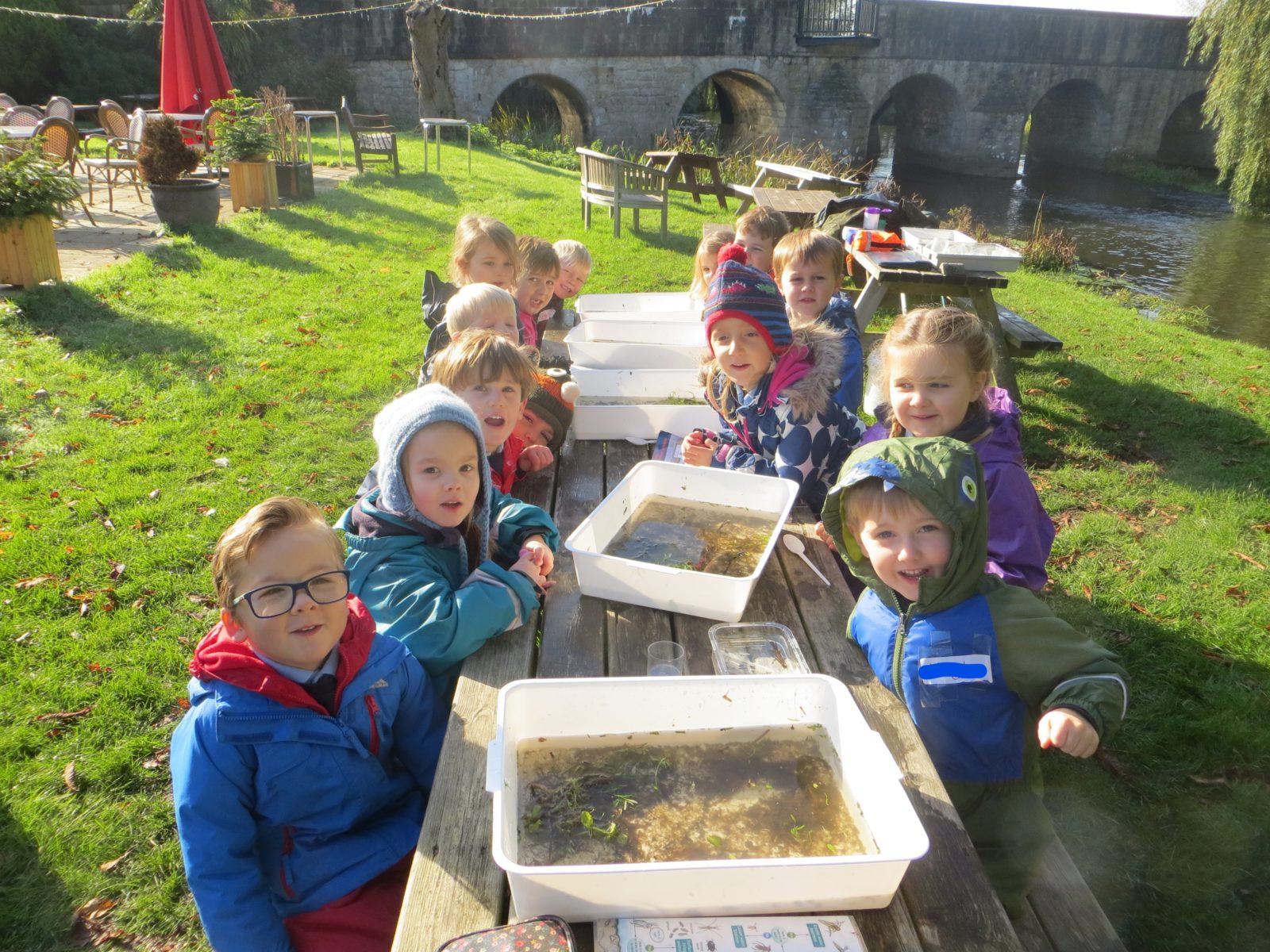 group school childrenwith trays of river dip samples