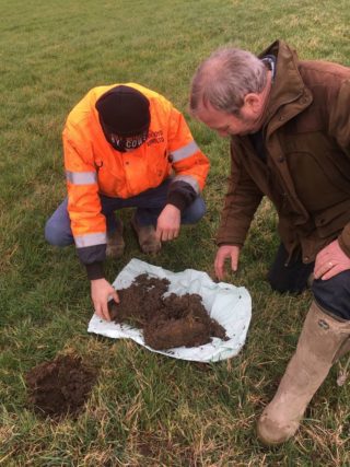 2 farmers with soil samples